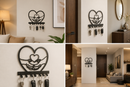 Detailed human hands supporting a line art heart silhouette inside a larger heart metal wall key holder with 7 hooks by Metal Studio